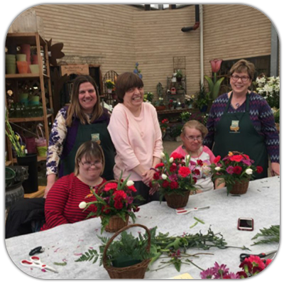 Goodwill particpants take a tour of Waukesha Floral and Greenhouse and learn about different flowers and plants.