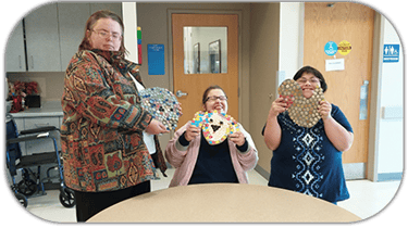 Goodwill Community Opportunities Club West Members with mosaic artwork