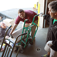 Trevor was learning how to use the pallet jack with assistance from Shawn his manager.